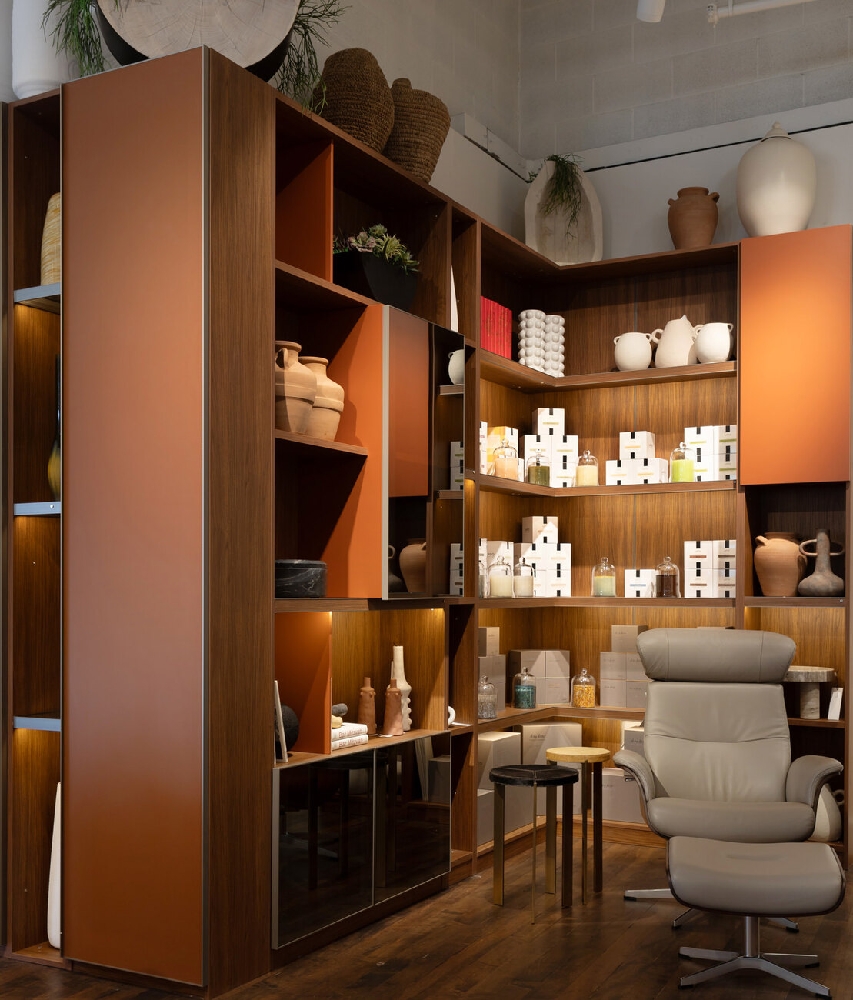 HW Home 9+CO Denver showroom walnut shelving display with Time Out recliner and ottoman