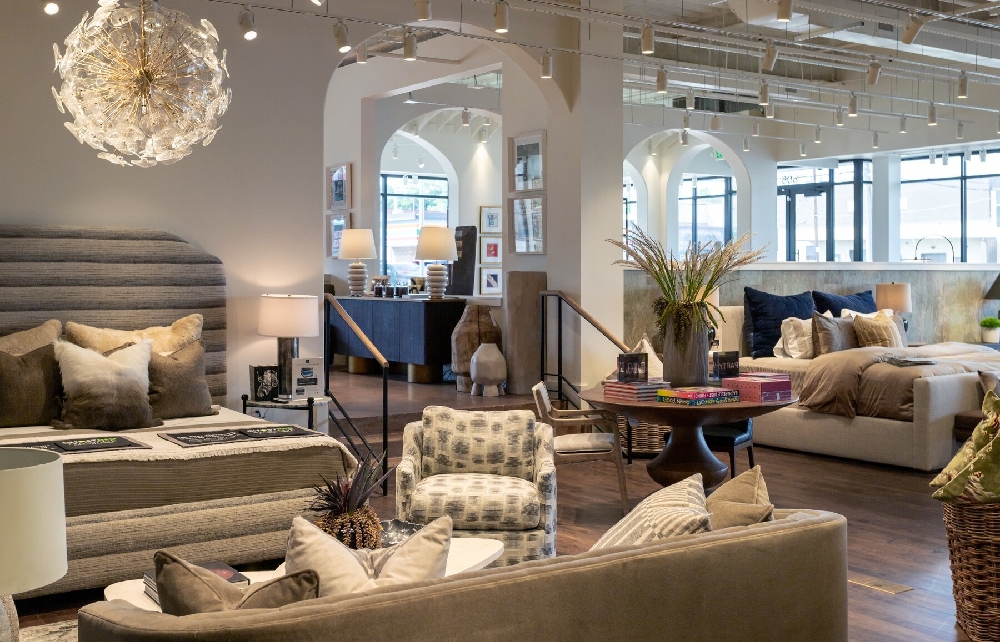 HW Home 9+CO Denver showroom with upholstered beds, lounge seating, stairs and architectural archways
