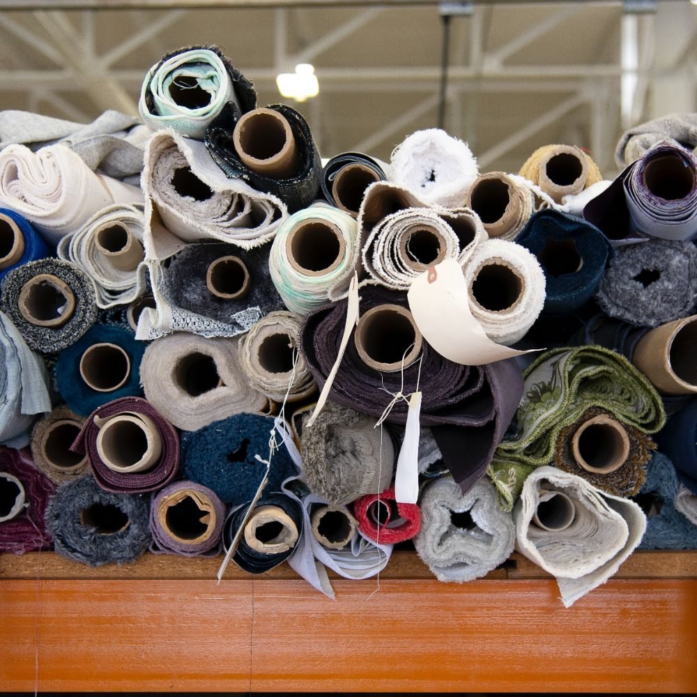 A selection of upholstery fabric rolls in varied colors and textures