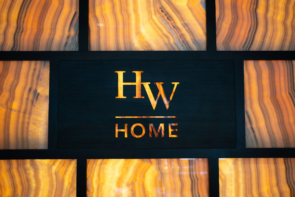 Backlit HW Home logo on onyx wall
